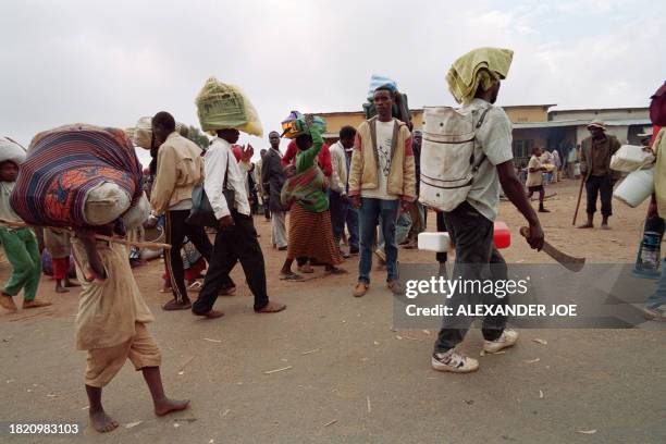 Refugees, fleeing the war-ravaged Rwandan capital facing ethnic violences and massacres in Rwanda, walk on the roadside, 23kms outside of Kigali, on...