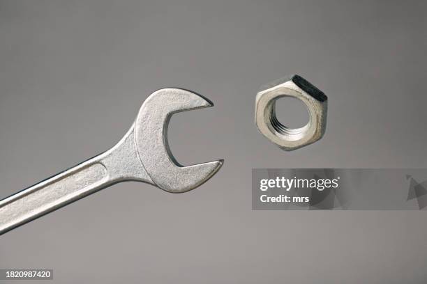 wrench and hexagon nut - schraubwerkzeug stock-fotos und bilder