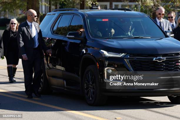 Former U.S. President Jimmy Carter rides in a car following a hearse carrying the remains of former first lady Rosalynn Carter Plains, GA, after a...