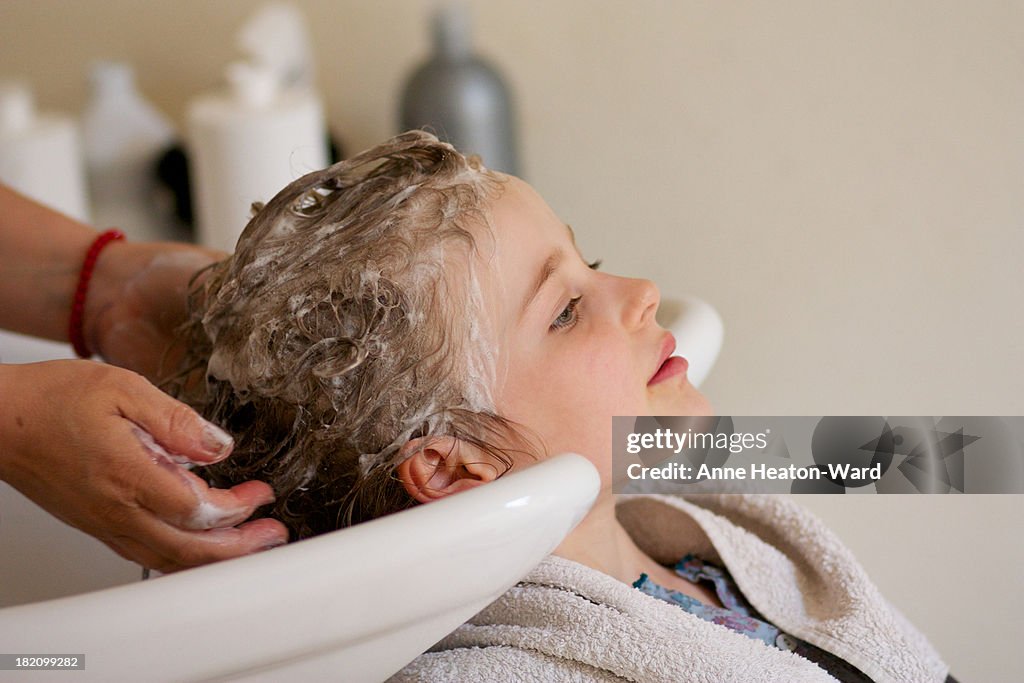 Girl having hair wash at hairdressers