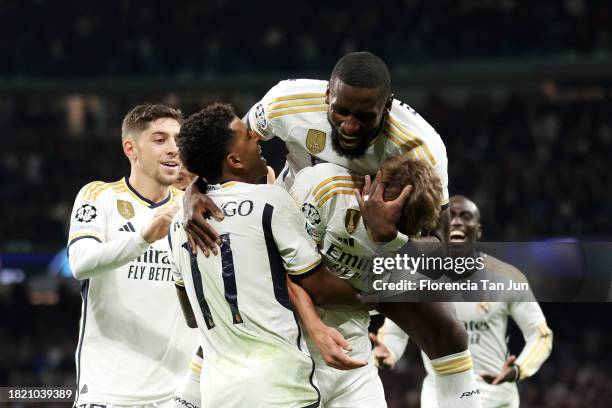 Nico Paz of Real Madrid celebrates with teammates after scoring the team's third goal during the UEFA Champions League match between Real Madrid and...