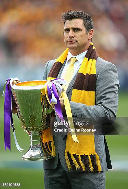 Shane Crawford delivers the Premiership Cup during the 2013 AFL Grand Final match between the Hawthorn Hawks and the Fremantle Dockers at Melbourne...