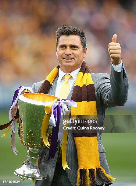 Shane Crawford delivers the Premiership Cup during the 2013 AFL Grand Final match between the Hawthorn Hawks and the Fremantle Dockers at Melbourne...