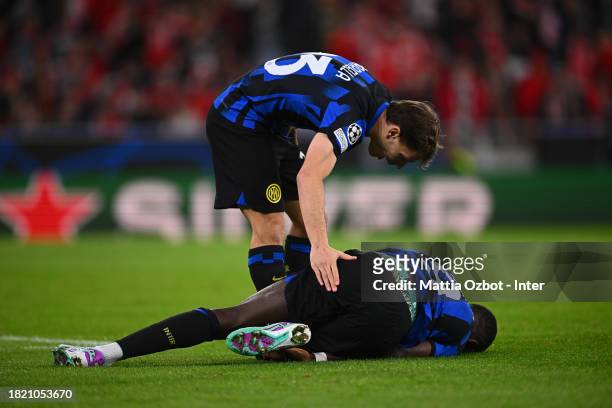 Nicolo Barella of FC Internazionale reacts with Marcus Thuram during the UEFA Champions League match between SL Benfica and FC Internazionale at...