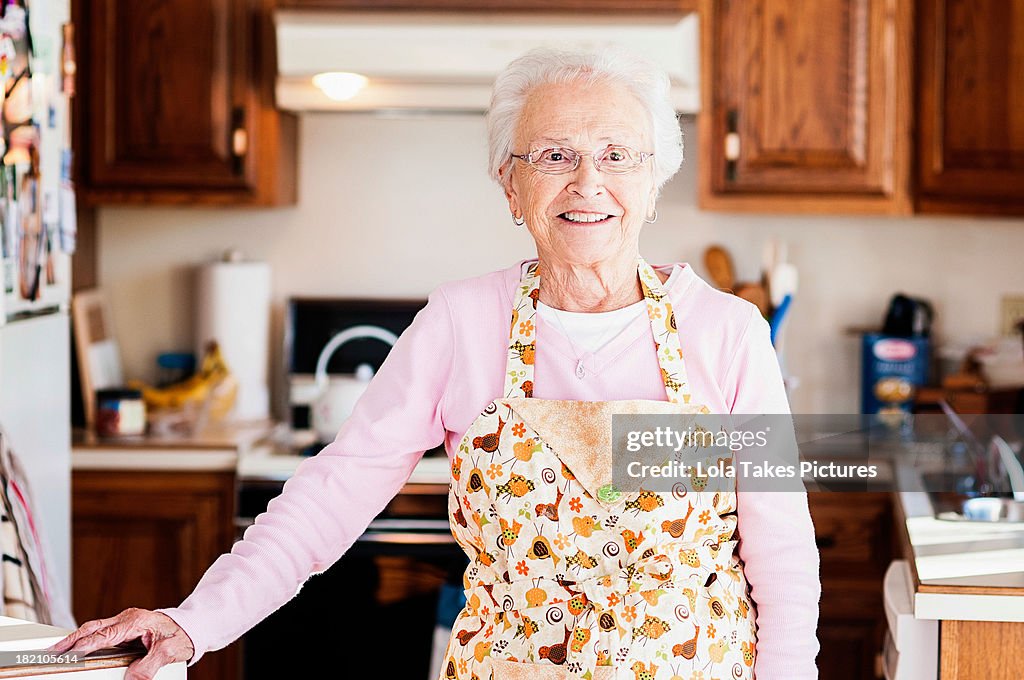 Grandmother standing in her kitchen