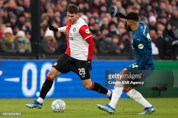 Santiago Gimenez of Feyenoord is challenged by Ismael Saibari of PSV during the Dutch Eredivisie match between Feyenoord and PSV at Stadion...