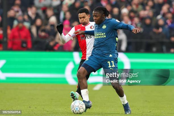 Johan Bakayoko of PSV is challenged by Marcos Lopez of Feyenoord during the Dutch Eredivisie match between Feyenoord and PSV at Stadion Feijenoord on...