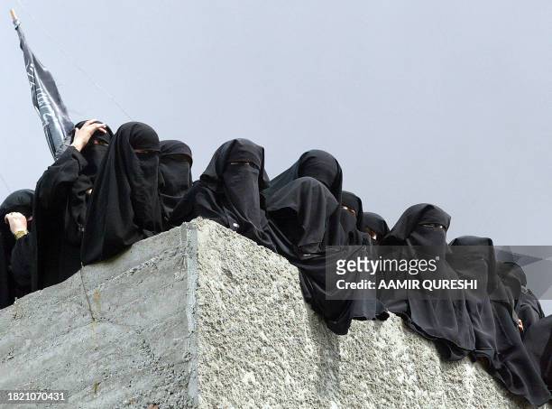 Pakistani Burqa-clad female students gather on the roof of Jamia Hafsa school during a protest in Islamabad, 06 April 2007. Thousands of CDs and DVDs...