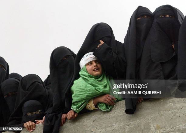 Pakistani Burqa-clad female students gather on the roof of Jamia Hafsa school during a protest in Islamabad, 06 April 2007. Thousands of CDs and DVDs...