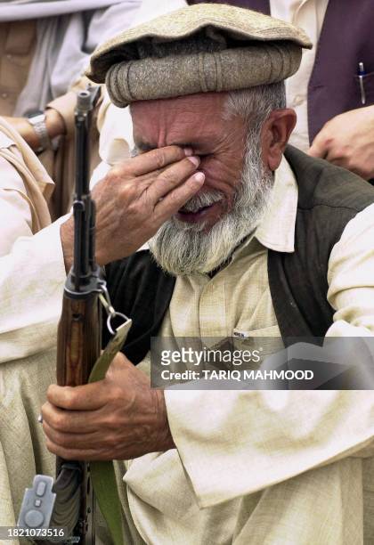 Grieved tribesman from Pakistan's fundamentalist Islamic party, Jamaat-i-Islami , weeps over the deaths of Iraqi people killed by the US-led...