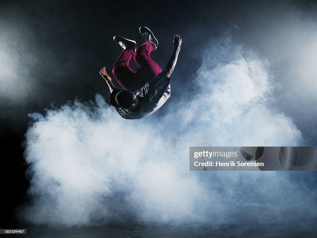Dancer leaping through smoke