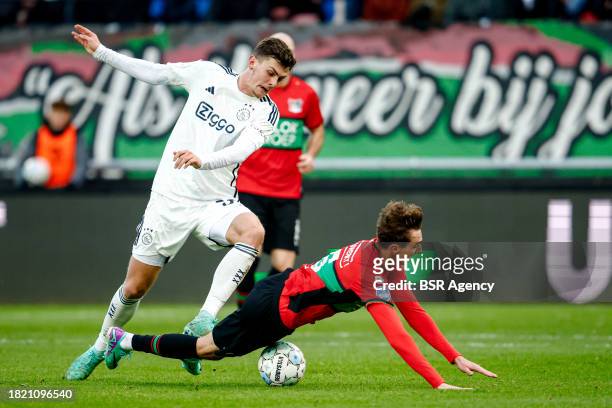 Benjamin Tahirovic of AFC Ajax battles for possession with Youri Baas of NEC falling down during the Dutch Eredivisie match between NEC Nijmegen and...
