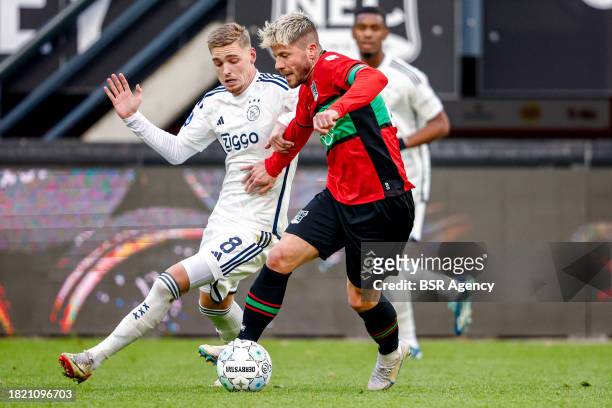 Kenneth Taylor of AFC Ajax battles for possession with Lasse Schone of NEC during the Dutch Eredivisie match between NEC Nijmegen and AFC Ajax at...