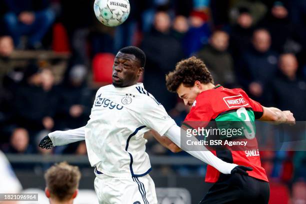 Brian Brobbey of AFC Ajax heads the ball Philippe Sandler of NEC during the Dutch Eredivisie match between NEC Nijmegen and AFC Ajax at...