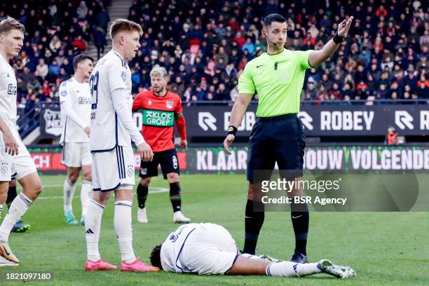 Devyne Rensch of AFC Ajax injured, Kristian Hlynsson of AFC Ajax, Referee Marc Nagtegaal during the Dutch Eredivisie match between NEC Nijmegen and...