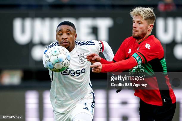 Steven Bergwijn of AFC Ajax battles for possession with Lasse Schone of NEC during the Dutch Eredivisie match between NEC Nijmegen and AFC Ajax at...