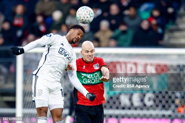 Chuba Akpom of AFC Ajax heads the ball with Bram Nuytinck of NEC during the Dutch Eredivisie match between NEC Nijmegen and AFC Ajax at...
