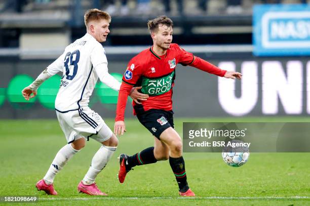 Kristian Hlynsson of AFC Ajax battles for possession with Dirk Proper of NEC during the Dutch Eredivisie match between NEC Nijmegen and AFC Ajax at...