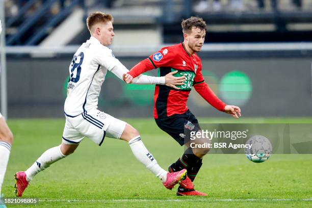 Kristian Hlynsson of AFC Ajax battles for possession with Dirk Proper of NEC during the Dutch Eredivisie match between NEC Nijmegen and AFC Ajax at...