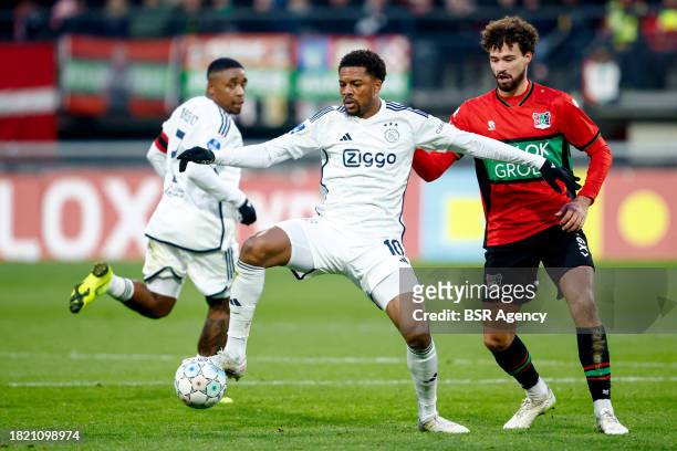 Chuba Akpom of AFC Ajax battles for possession with Philippe Sandler of NEC during the Dutch Eredivisie match between NEC Nijmegen and AFC Ajax at...