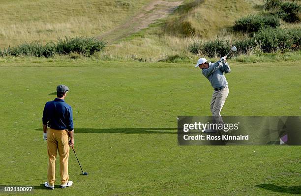 Michael Vaughan the former England cricket captain watches another former England captain Andrew Strauss tee off on the par four 6th hole during the...