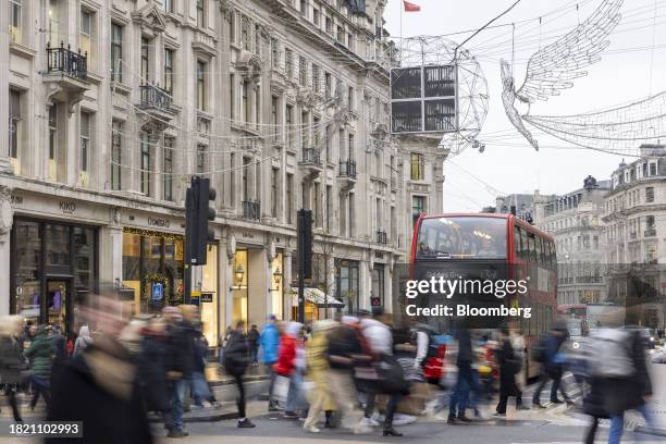 Shoppers on Oxford Street in London, UK, on Monday, Dec. 4, 2023. Inflation in UK shops has fallen to a 17-month low as retailers fight to attract...