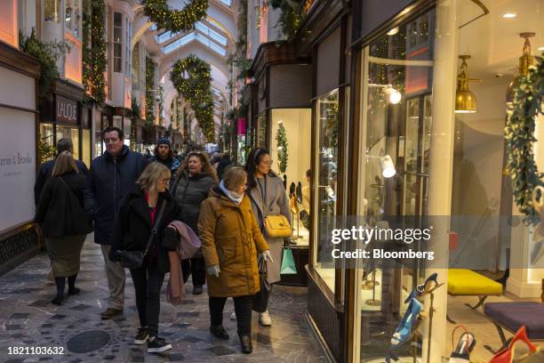 Pedestrians walk through the festively decorated Burlington Arcade luxury shopping arcade in London, UK, on Monday, Dec. 4, 2023. Inflation in UK...