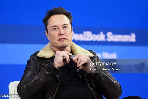 Elon Musk wears a necklace in honor of Israeli hostages onstage during The New York Times Dealbook Summit 2023 at Jazz at Lincoln Center on November...