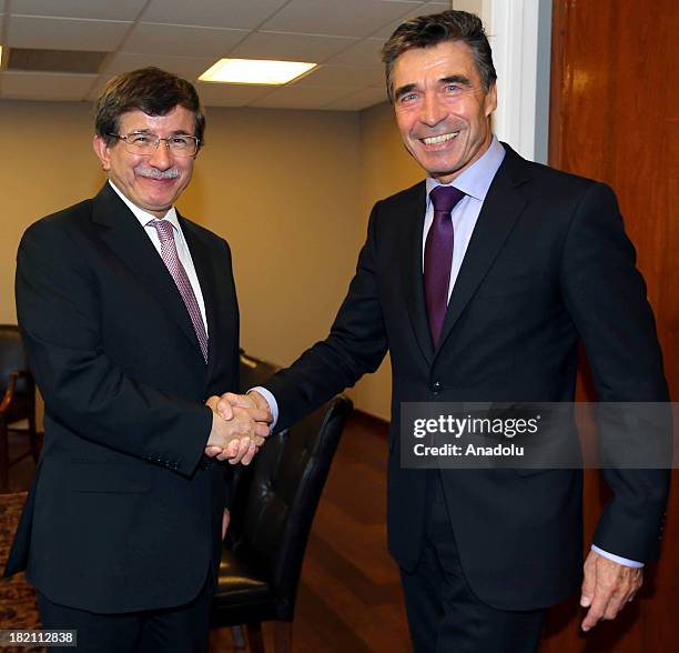 Turkish Foreign Minister Ahmet Davutoglu shakes hand with NATO Secretary General Anders Fogh Rasmussen on the sidelines of the 68th session of the...