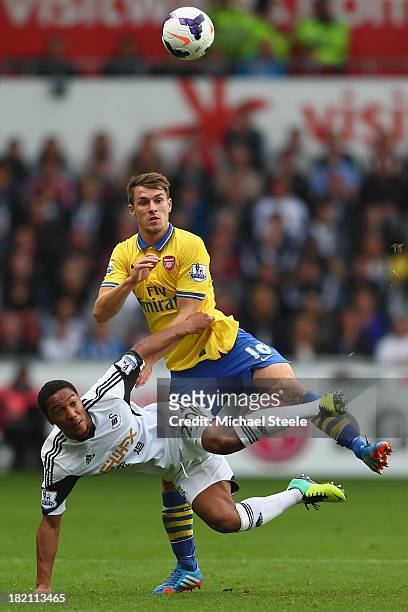 Jonathan de Guzman of Swansea City loses out to a challenge from Aaron Ramsey of Arsenal during the Barclays Premier League match between Swansea...