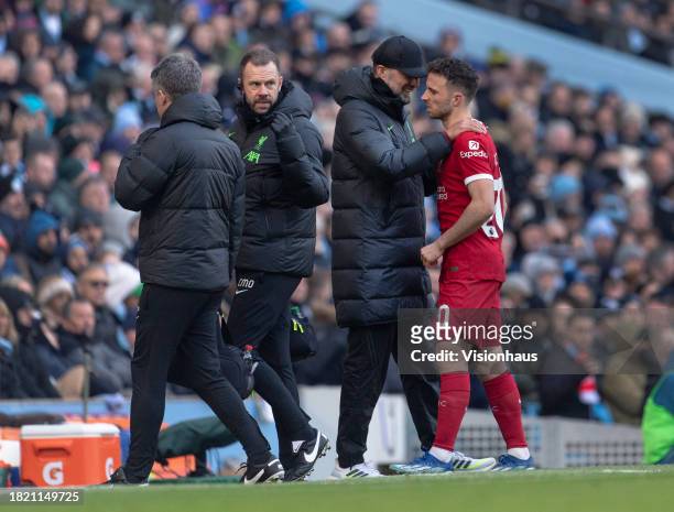Liverpool manager Jurgen Klopp greets Diogo Jota after he is substituted due to injury during the Premier League match between Manchester City and...