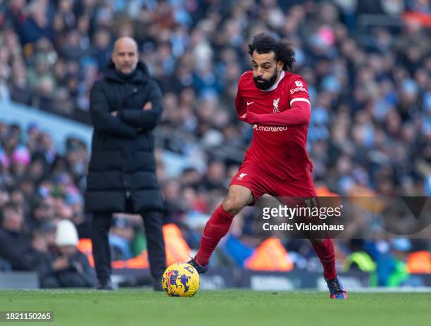 Mohamed Salah of Liverpool is watched by Manchester City manager Jurgen Klopp during the Premier League match between Manchester City and Liverpool...