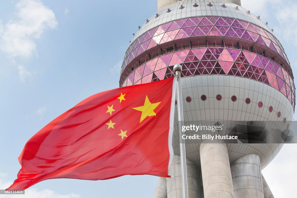 Shanghais Oriental Pearl Tower And Chinese Flag High-Res Stock Photo