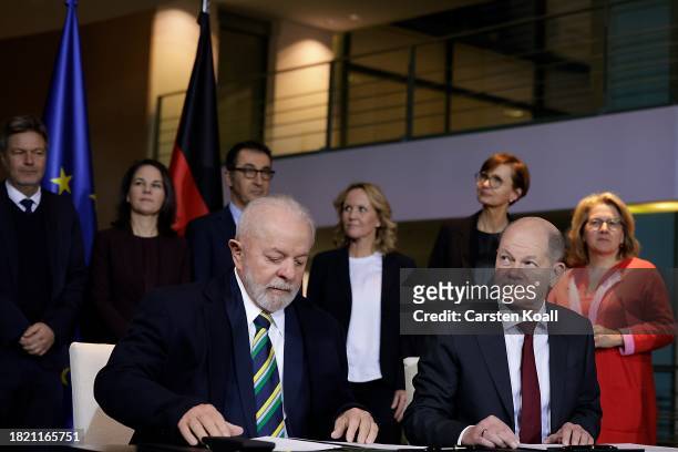 German Chancellor Olaf Scholz and Brazilian President Luiz Inacio Lula da Silva sign a bilateral contract at Chancellory on December 4, 2023 in...