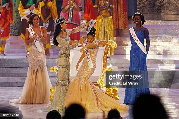 Miss Philippines, Megan Young is helped on with her new sash by Miss World 2012 Wenxia Yu of China as she is crowned Miss World during Miss World...