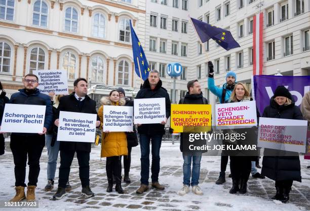 People hold placards reading : "Schengen is our right", "European solidarity: Romania and Bulgaria now in the Schengen zone", "Romania deserves being...