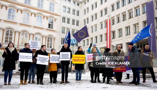 People hold placards reading : "Schengen is our right", "European solidarity: Romania and Bulgaria now in the Schengen zone", "Romania deserves being...