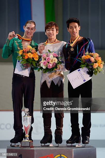 Nobunari Oda of Japan, Jason Brown of the United States and Jeremy Ten of Canada pose at the victory ceremony of the Men's competition during day...