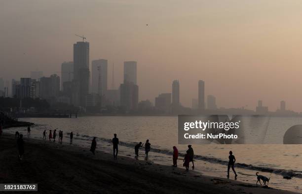High-rise buildings are visible through dense smog near the sea beach in Mumbai, India, on December 4, 2023. India's financial capital, Mumbai, is...