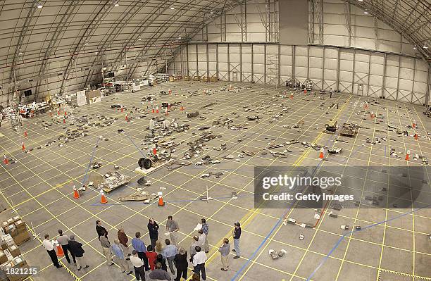 In this NASA handout photo, NASA crash investigators place debris from the Space Shuttle Columbia on a grid on the floor of a hangar on February 28,...