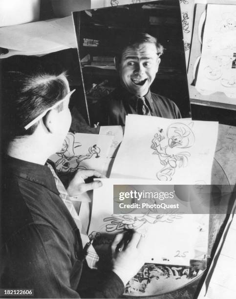 At Walt Disney Studios, an unidentified animator makes faces in a mirror which he uses as raw material for his character's expressions, California,...