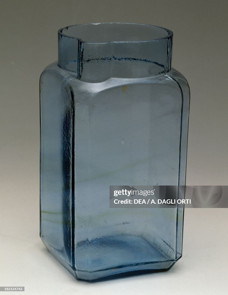 Azure glass vase with a square base and a spout...