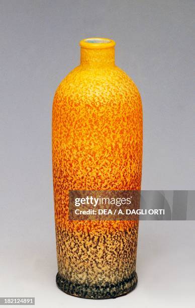 Liqueur bottle, 1930s, polychrome majolica with orange peel texture, MGA manufacture, Italy, 20th century.