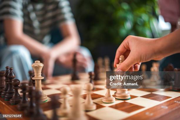 joyful family mastering chess together - chess strategy stock pictures, royalty-free photos & images