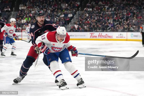 Erik Gudbranson of the Columbus Blue Jackets battles Brendan Gallagher of the Montreal Canadiens for position on the ice during the first period at...