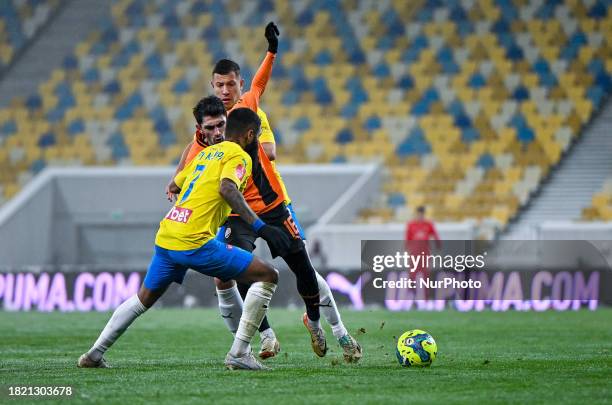 In Lviv, Ukraine, on December 3 defender Irakli Azarov of FC Shakhtar Donetsk is competing with forward Andrii Boriachuk and midfielder Ari Moura of...