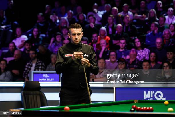 Mark Selby of England chalks the cue in the second round match against Barry Hawkins of England on day 5 of the 2023 MrQ UK Championship at Barbican...