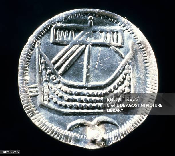 Silver coin bearing the image of a drakkar boat, minted in Hedeby, Denmark. Viking coins, 10th century.