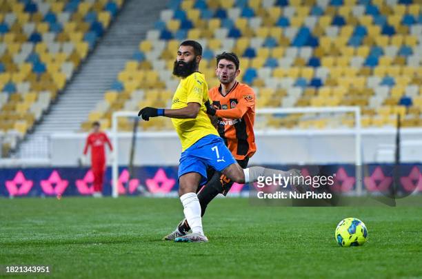 In Lviv, Ukraine, on December 3 defender Irakli Azarov of FC Shakhtar Donetsk is in action with midfielder Ari Moura of FC Metalist 1925 Kharkiv...