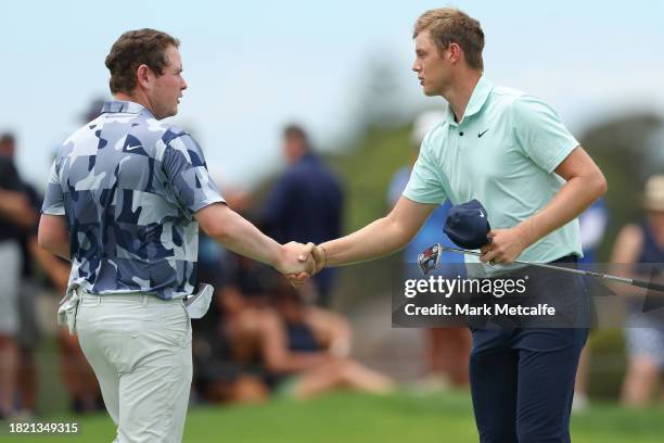 Cameron Davis of Australia shakes hands with Robert MacIntyre of Scotland after the 9th hole and their round during the ISPS HANDA Australian Open at...